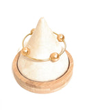 Blessings Gold & Gold 12 MM Pearl Bracelet on display stand.