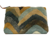 INZI faux fur clutch handbag with chevron pattern and top zipper closure.